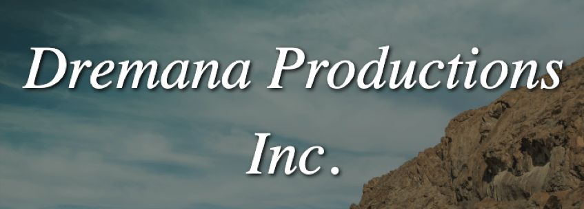 The test “Dremana Productions Inc.” in front of a cloud-filled blue sky and a cliff.